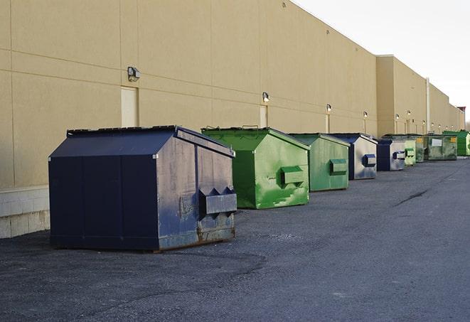 construction dumpsters stacked in a row on a job site in Burton